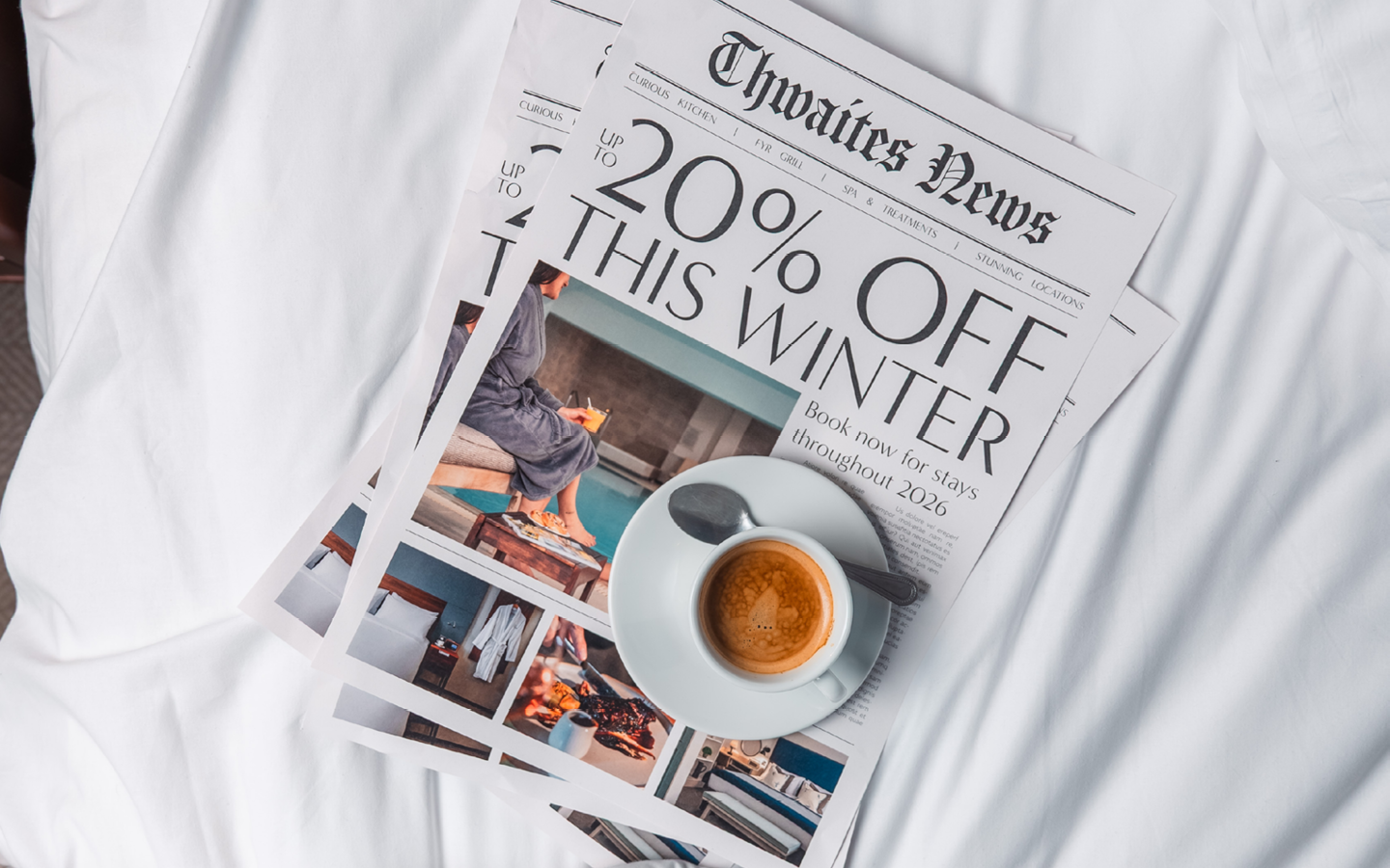"up to 20% off this winter" newspaper on a bed with a coffee