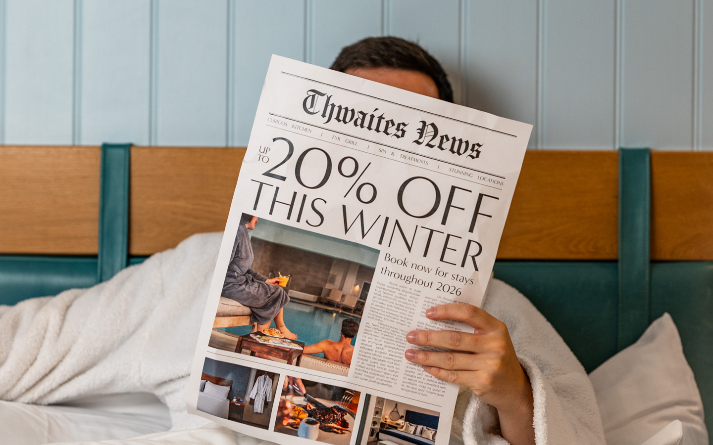 "up to 20% off this winter" newspaper being held in a hotel bed